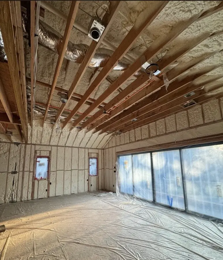Interior walls and ceiling insulated with spray foam during new construction in Toronto